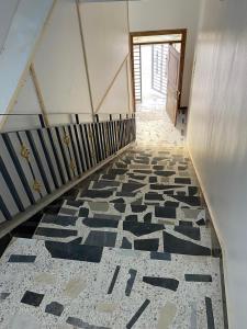 a stairway with a black and white tile floor at Appartement 3 in Al Hoceïma