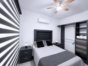 a bedroom with a bed and a ceiling fan at Nice AptPoolBeach ClubParkingGymACBarraVieja in Barra Vieja +67 photos