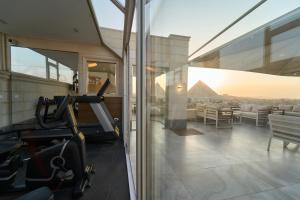 a gym in a building with a view of the pyramid at Kemet Pyramids View Hotel in Cairo
