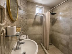 a bathroom with a sink and a shower at Megobroba Hotel in Kobuleti +79 photos