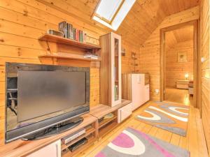 a living room with a large television in a cabin at Karawankenpanorama S in Liebenfels
