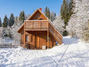 a log cabin in the snow at Karawankenpanorama S in Liebenfels