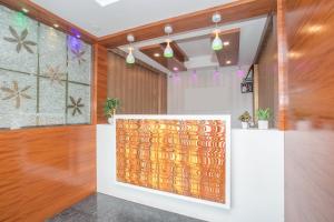 an office lobby with a large painting on the wall at Hotel O Royal Stay in Bangalore