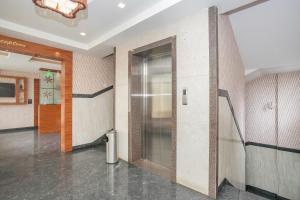 a hallway with a elevator in a building at Hotel O Royal Stay in Bangalore