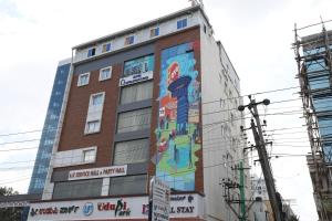 a building with a mural on the side of it at Hotel O Royal Stay in Bangalore