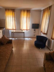 a living room with a couch and a table and a tv at Safari Suit Hotel , Side in Side