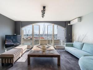 a living room with a couch and a table at De Brouwersdam in Ouddorp
