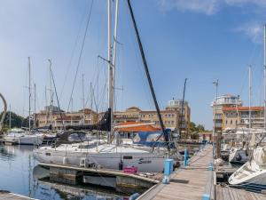 a group of boats docked in a marina with buildings at De Brouwersdam in Ouddorp