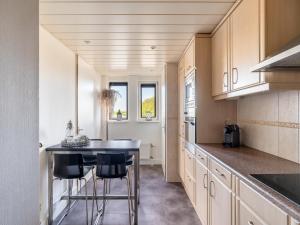 a kitchen with a table and some chairs in it at De Brouwersdam in Ouddorp