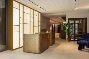 a lobby with a reception desk in a building at Hotel Leev Miromesnil & Spa in Paris