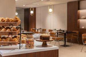 a bakery with a display of bread and pastries at Hotel Leev Miromesnil & Spa in Paris
