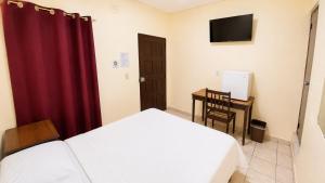 a bedroom with a bed and a desk and a television at Hotel King del Centro San Miguel in San Miguel +19 photos