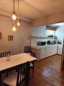a kitchen and dining room with a table and chairs at Dpto Plaza Colon in Azul