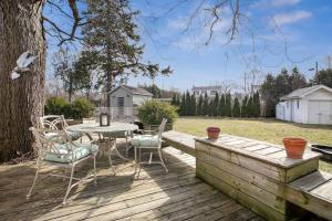 a wooden deck with a table and chairs on it at Modern 3BR Home, Minutes to Lake & Port Credit in Mississauga