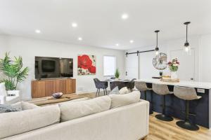 a living room with a white couch and a table at Modern 3BR Home, Minutes to Lake & Port Credit in Mississauga