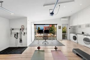 a kitchen with a table and a chair in a room at Whakata on McBride in Queenstown