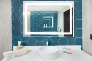 a bathroom with a sink and a mirror at Le Méridien Mexico City Reforma in Mexico City