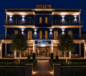 a hotel with a sign in front of it at night at Hotel IL MULINO - Colazione a Buffet e Parcheggio Privato in Casalgrande