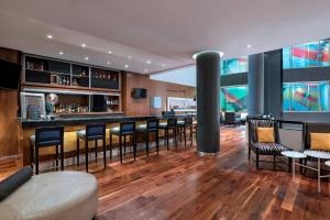a bar in a hotel with chairs and tables at Le Méridien Mexico City Reforma in Mexico City