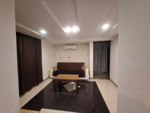 a living room with a couch and a table at emplus in Batumi