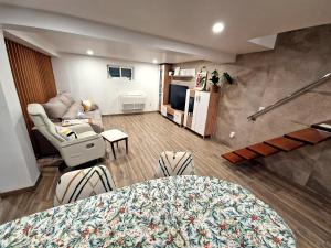 a living room with a couch and a table at Private Pool House Minutes from the Beach in Charneca