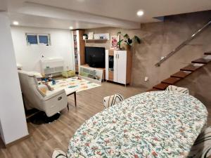 a living room with a table and a chair at Private Pool House Minutes from the Beach in Charneca