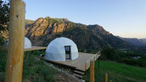 two white tents on a hill with a mountain at Glamping Yeghegis in Yeghegis
