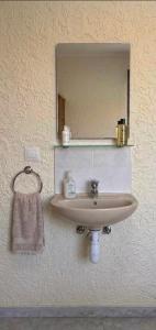 a bathroom sink with a mirror and a towel at Los Hermanos in Viladecáns