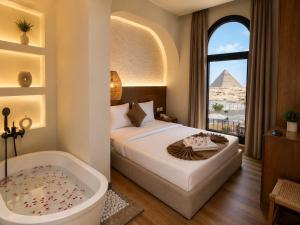 a bedroom with a bed and a tub and the pyramid at Le Pacha Pyramids Hotel in Cairo