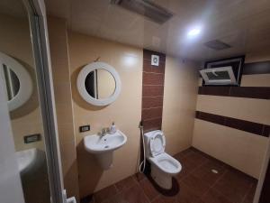 a bathroom with a toilet and a sink at emplus in Batumi +13 photos