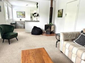 a living room with a couch and a stove at Gone Potty 1 in Alexandra