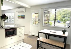 a kitchen with a table and a microwave at Gone Potty 1 in Alexandra