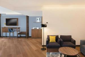 a living room with a couch and a table at Le Méridien Mexico City Reforma in Mexico City