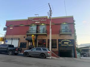 a car parked in front of a restaurant at Hotel sierra palace in Cuauhtémoc