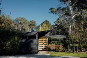 a house in the bush with a garage at The Artemis Cottage in Fitzroy
