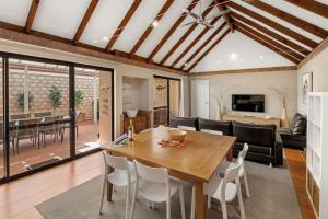 a dining room and living room with a table and chairs at Clearwater - Cosy Comforts Steps from the Beach in Dunsborough +14 photos