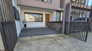 an empty entrance to a house with a gate at La Escondida in Chascomús
