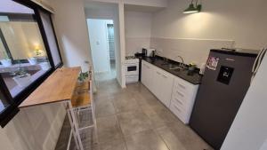 a kitchen with a black refrigerator and a counter at La Escondida in Chascomús