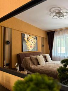 a living room with a bed and a couch at Green Escape in Slănic-Moldova