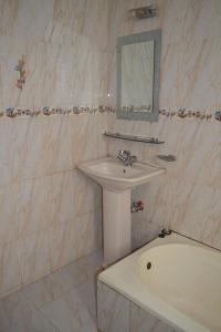 a bathroom with a sink and a bath tub at Hotel Shams Plaza in Cox's Bazar +49 photos