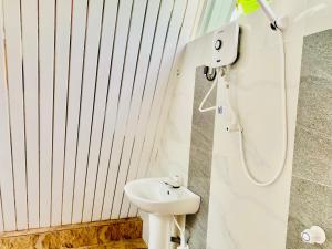 a bathroom with a white toilet and a sink at Marina Safari Resort Udawalawe in Udawalawe +45 photos