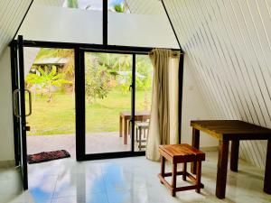 a room with a table and a bench and a window at Marina Safari Resort Udawalawe in Udawalawe