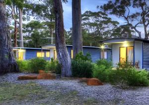 a house in the woods at night at Bruny Island Holiday Park in Adventure Bay