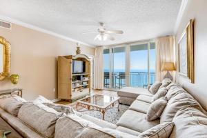 a living room with a couch and a table at Spacious Gulf Front Condo with Private WD and Shared Pool in Navarre