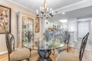 a dining room with a glass table and chairs at Spacious Gulf Front Condo with Private WD and Shared Pool in Navarre +20 photos
