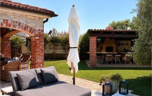 a patio with an umbrella in a yard at Villa Novel in Višnjan +27 photos