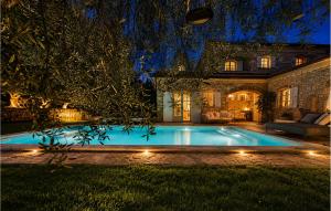 a swimming pool in the yard of a house at Villa Novel in Višnjan