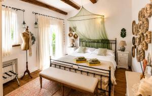 a bedroom with a bed and a bench in it at Villa Novel in Višnjan