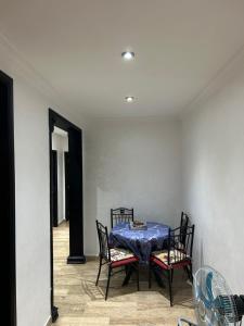 a dining room table with chairs and a blue table cloth at Man Wee Apprt in Tangier