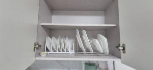 a row of white plates sitting on a shelf at 1&2stayㅡH in Tongdaegu-yŏk